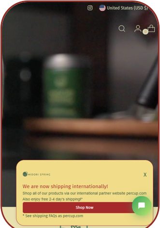 Midori Spring storefront with an international shipping popup reading 'We are now shipping internationally!' and a Shop Now button