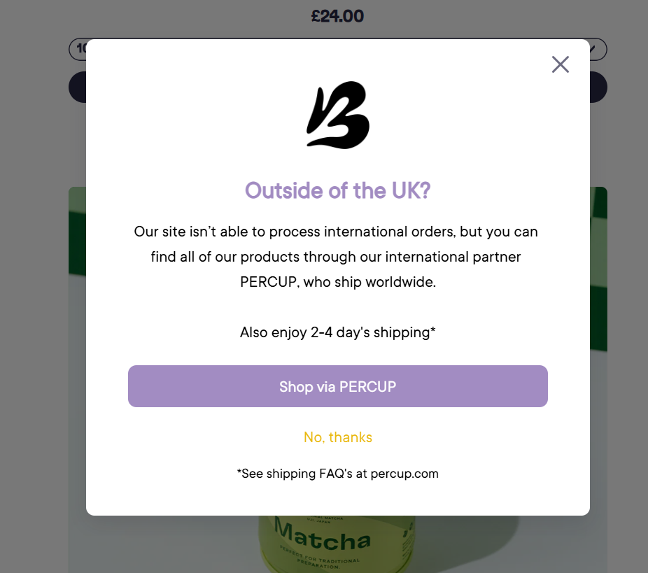 A live popup on a brand's product page reading 'Outside of the UK? Our site isn't able to process international orders, but you can find all of our products through our international partner PERCUP' with a 'Shop via PERCUP' button
